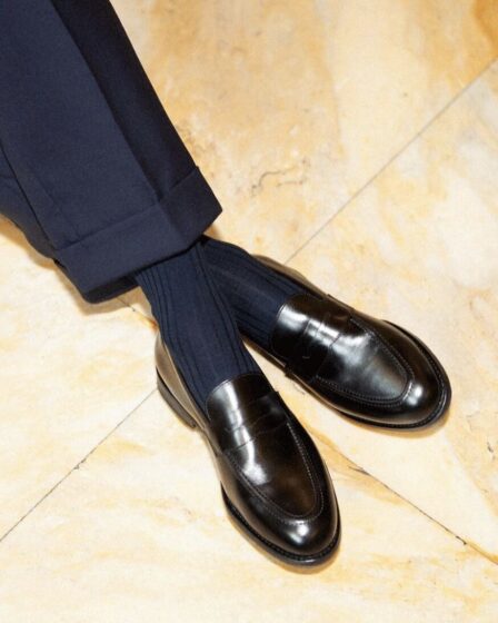 tailored navy pants, matching socks and black dress shoes