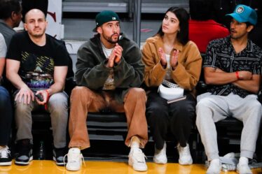 Bad Bunny and model Rachel Carrillo watch from the sidelines during the second quarter between the Los Angeles Lakers and the Oklahoma City Thunder at Crypto.com Arena on Tuesday, Feb. 7, 2023 in Los Angeles.