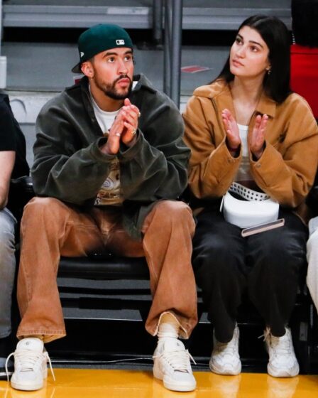 Bad Bunny and model Rachel Carrillo watch from the sidelines during the second quarter between the Los Angeles Lakers and the Oklahoma City Thunder at Crypto.com Arena on Tuesday, Feb. 7, 2023 in Los Angeles.