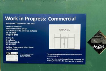 A public government poster for a work in progress commercial site that names Chanel.