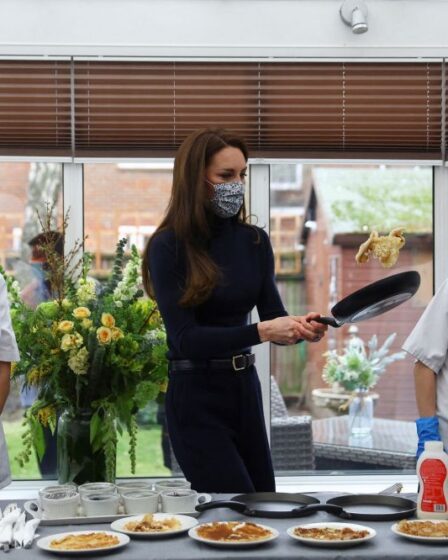 Kate Middleton prepares pancakes during a visit of the Oxford House nursing home in Slough, Eng. on Feb. 21, 2023.