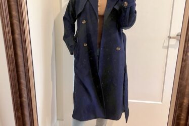 Woman wearing the Old Navy Double-Breasted Tie-Belt Trench Coat in navy unbuttoned.