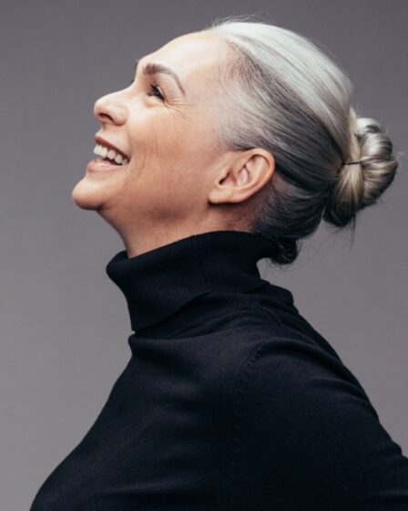 profile of smilling woman with gray hair pulled back