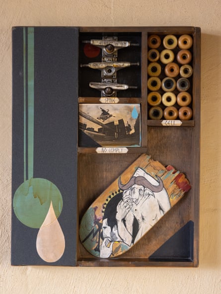 A portrait of Morgan Campbell which incorporates skateboarding parts, a photograph of Morgan Campbell, and a broken skateboard deck with a minotaur-like illustration.