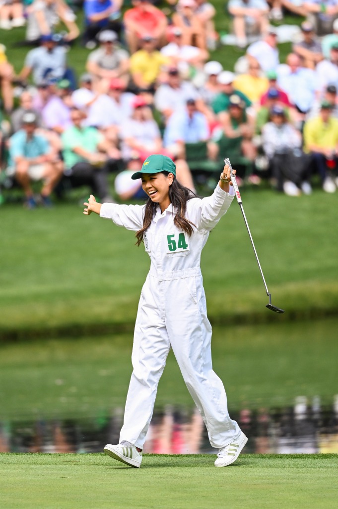 Katherine Zhu, fiancee of Collin Morikawa, smiles and celebrate after making a long putt during the Par Three Contest prior to the Masters at Augusta National Golf Club on April 6, 2022, in Augusta, Ga.