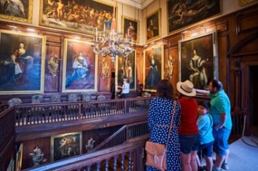 A family looking at artworks in Drumlanrig Castle