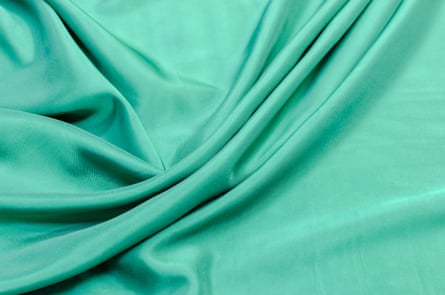 Close up of a mint-green fabric with drapes and folds.