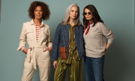 Three women in cream jumsuit, khaki stripe co-ord, and jeans and beige jumper