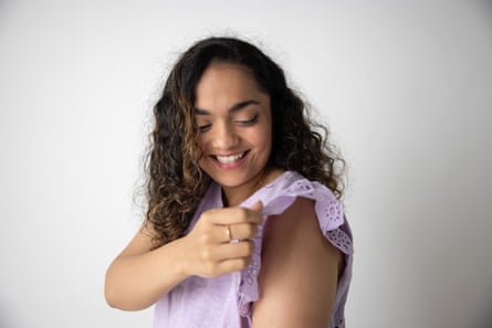 Karishma Luthria holds the sleeve of a purple top she is wearing