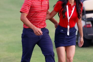 Collin Morikawa and his girlfriend Katherine Zhu walk to the closing ceremony for the 2022 Presidents Cup on Sept. 25, 2022 at Quail Hollow Club in Charlotte, North Carolina.