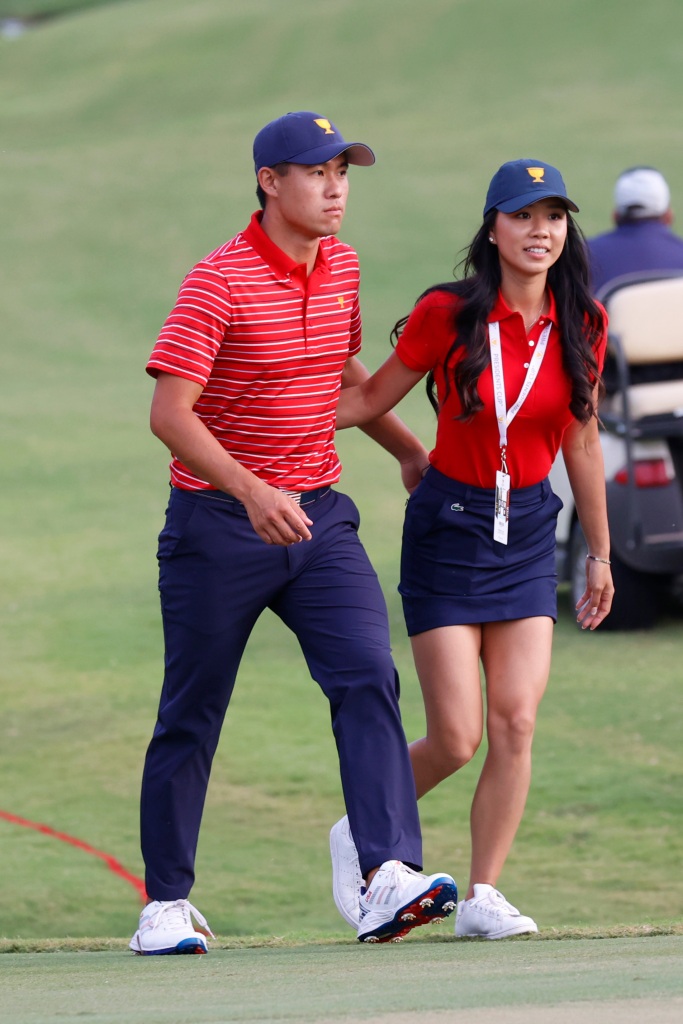 Collin Morikawa and his girlfriend Katherine Zhu walk to the closing ceremony for the 2022 Presidents Cup on Sept. 25, 2022 at Quail Hollow Club in Charlotte, North Carolina.