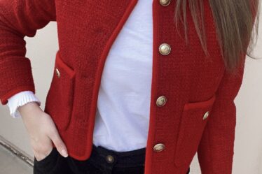 woman wearing me and em red boucle jacket, corduroy pants, and white layering shirt