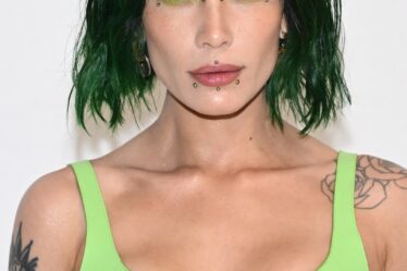 Halsey wears faux facial piercings green eye makeup and green hair to Givenchy show