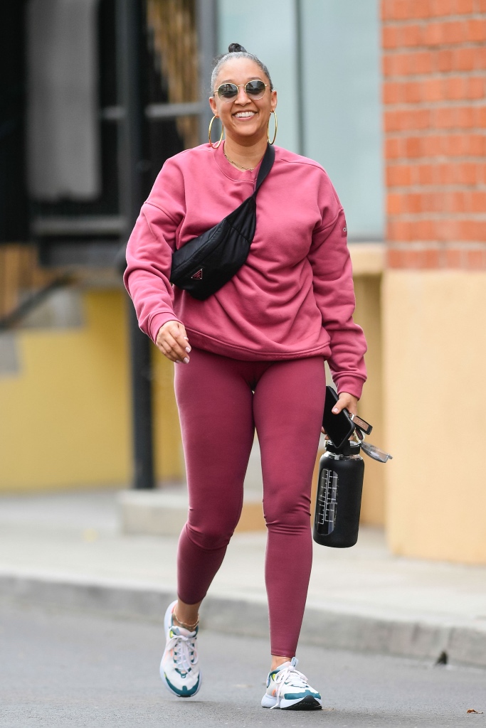 tia mowry, la, matching workout set, pink, leggings, sweatshirt, sneakers, belt bag