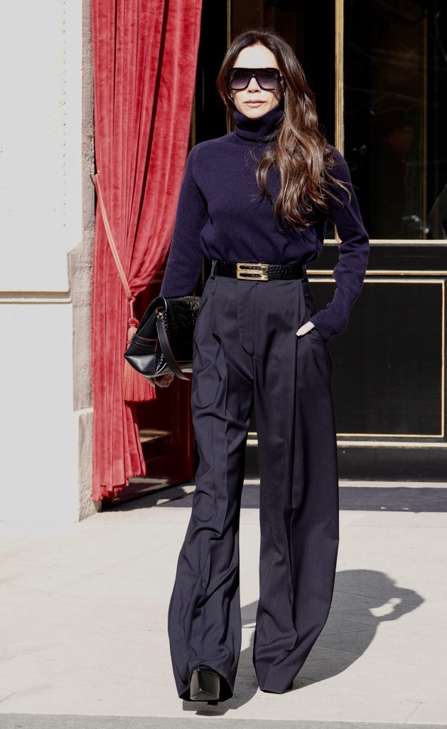 Victoria Beckham wearing a navy blue turtleneck sweater and trousers during paris fashion week