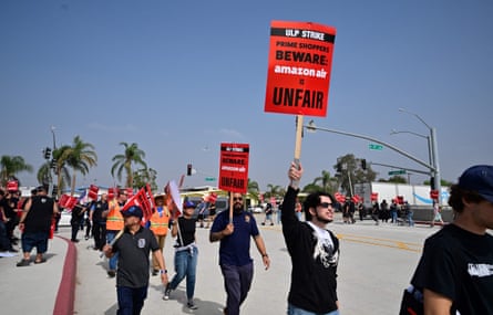 Workers at Amazon’s west coast air freight fulfillment center in San Bernardino, California, protest outside the facility on 14 October 2022 over claims of an unsafe work environment and low wages.