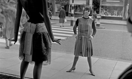 Mary Quant looking at a window display from outside her shop Bazaar in London in 1960.