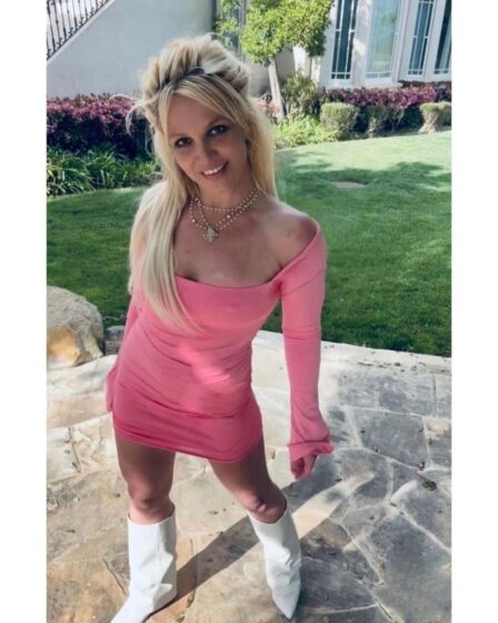 britney spears wearing a pink dress with white boots