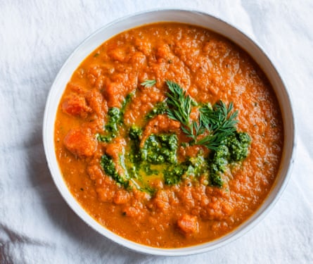 A soup of carrots, dressed with a pesto made from their feathery tops