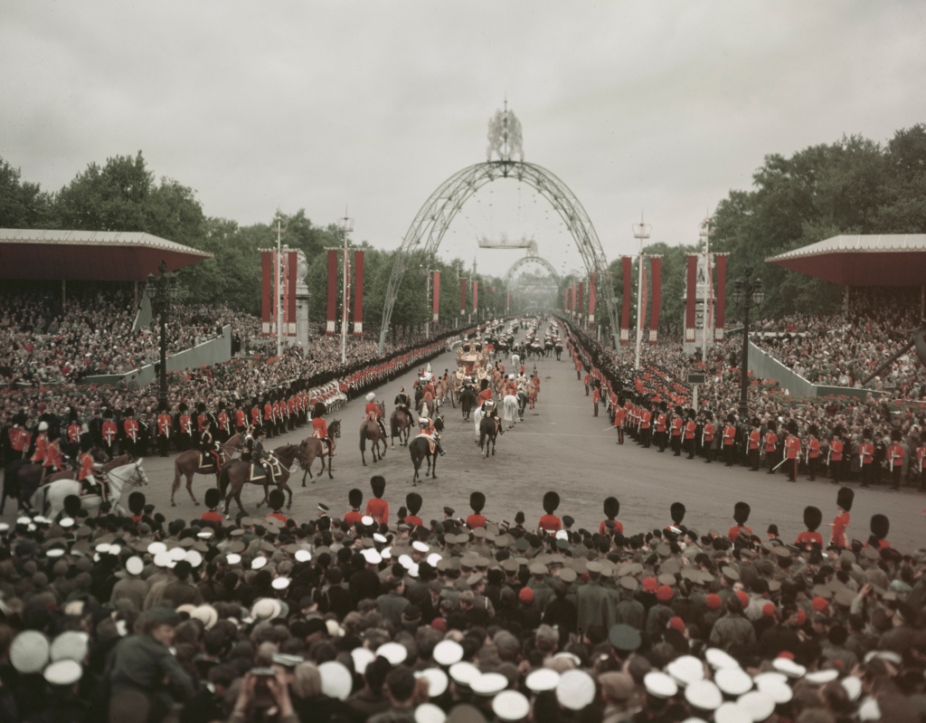 British sailors, soldiers and crowds line the route of Queen Elizabeth's coronation procession, the Mall, London, 2nd June, 1953. Coronation arches can be seen in the background. (Photo by Hulton Archive/Getty Images)
