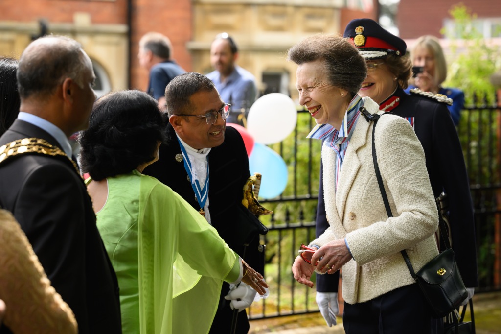 Princess Anne speaks with residents of a street as they hold a Coronation street party on May 07, 2023 in Swindon, England. 