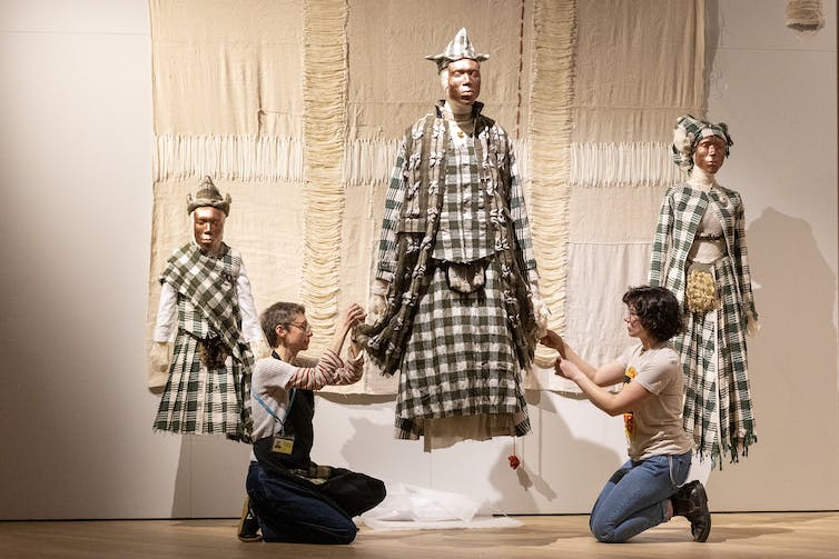 A family wearing brown kilts.