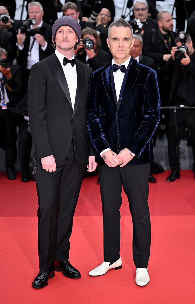 English singer-songwriter Robbie Williams (R) and Australian filmmaker Michael Gracey (L) arrive for the premiere of the film Killers of the Flower Moon 