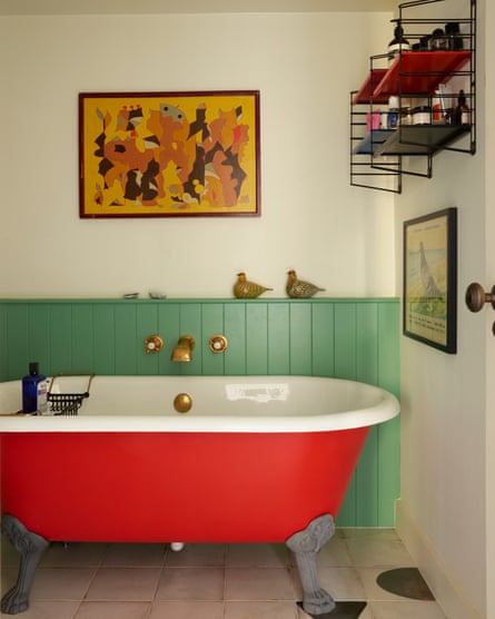 Bathroom, with red claw-foot bath in apartment.