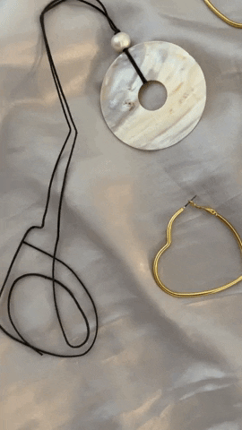 frasier sterling earrings and choker necklaces laying flat on silk