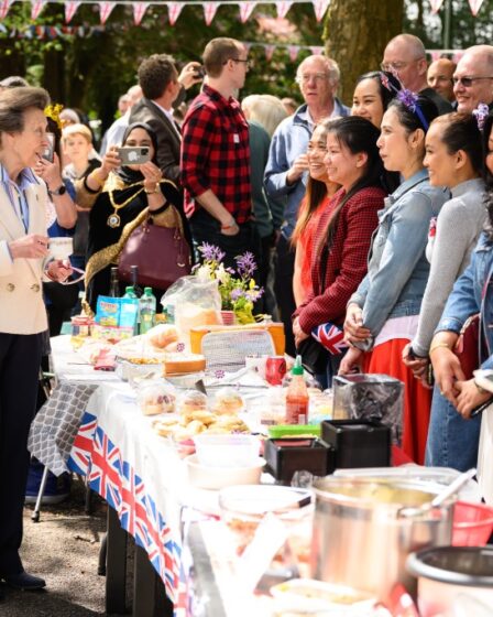 Princess Anne (L) speaks with residents of a street as they hold a Coronation street party on May 07, 2023 in Swindon, England.