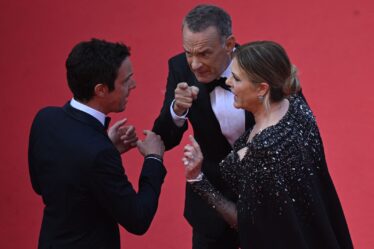 US actor Tom Hanks  and US actress Rita Wilson speak with a staff member as they arrive for the screening of the film...