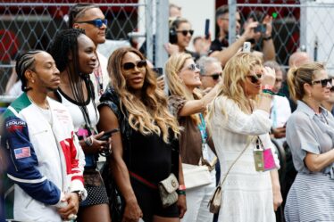 Ludacris, Venus Williams and Serena Williams watch the grid presentation prior to the F1 Grand Prix of Miami.