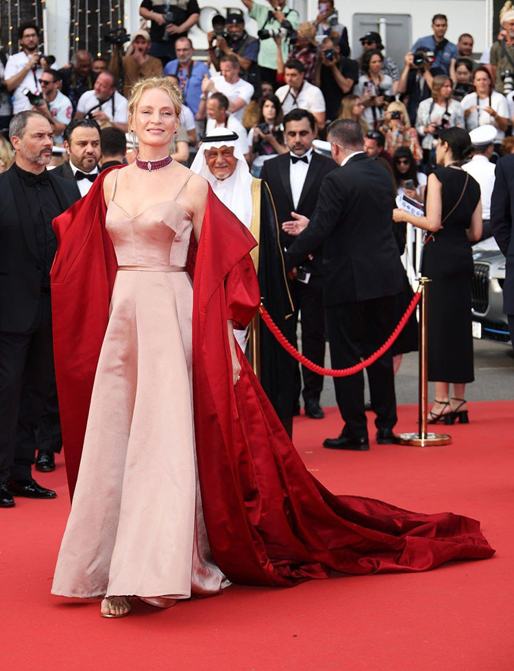 Uma Thurman Wore Dior Haute Couture To The ‘Jeanne du Barry’ Cannes Film Festival Premiere & Opening Ceremony
The ‘Jeanne du Barry’ Cannes Film Festival premiere and opening ceremony this evening (May 16) was Uma Thurman’s first major red carpet appearance of the year.

 

Sadly, for the actress, it will be one to forget.

 

While I’m glad she added the red cape to her Christian Dior Haute Couture blush coloured gown, to not only to prevent her from looking washed out, but to add some drama to the look, the cape itself – along with the dress – accumulated more and more creased with every photo.

 

Uma’s style is usually impeccable, but this was too unkempt for my liking.

 

This isn’t what I expect from an icon.

 

I would only save the Chopard choker from this look.

 