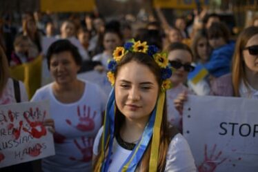 A woman wearing a flower crown in the colours of the Ukrainian flag attends a protest against Russia’s war in Ukraine, in front of the Russian embassy in Bucharest, Romania.