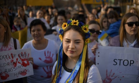 A woman wearing a flower crown in the colours of the Ukrainian flag attends a protest against Russia’s war in Ukraine, in front of the Russian embassy in Bucharest, Romania.