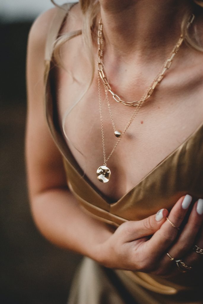 the world of jewelry - how to create your own jewelry brand - woman wearing necklaces and rings
