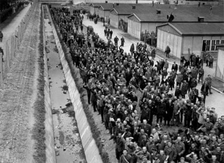 Prisoners at Dachau cheer as US forces arrive to liberate the camp in May 1945