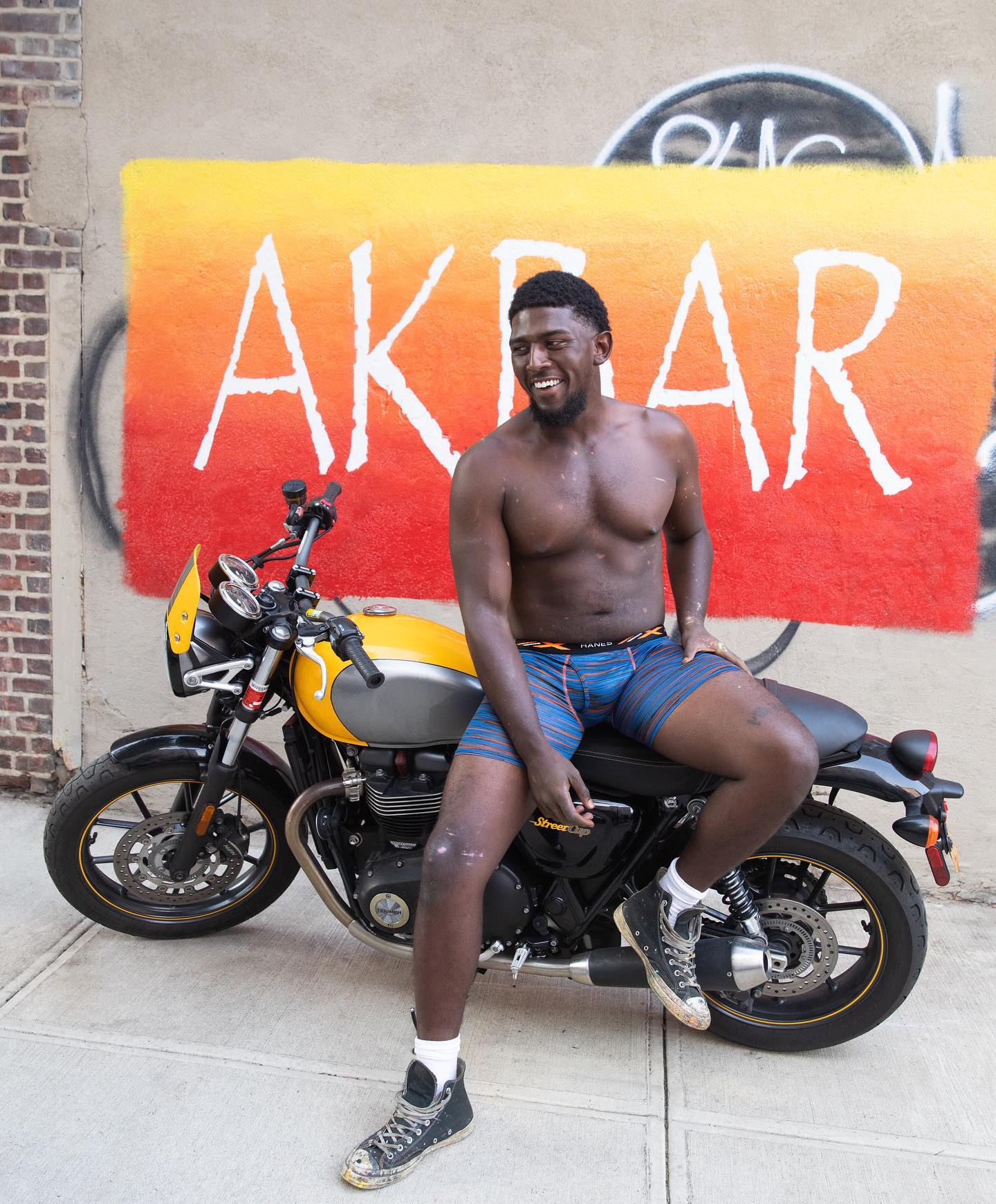 man in boxer brief sitting on a motorcycle