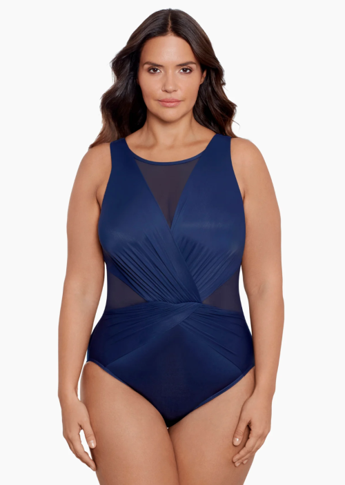 Model wearing navy blue one-piece swimsuit from Miraclesuit