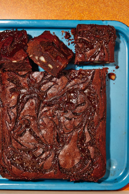 A blue baking tray of brownies with a tamarind caramel swirl on top