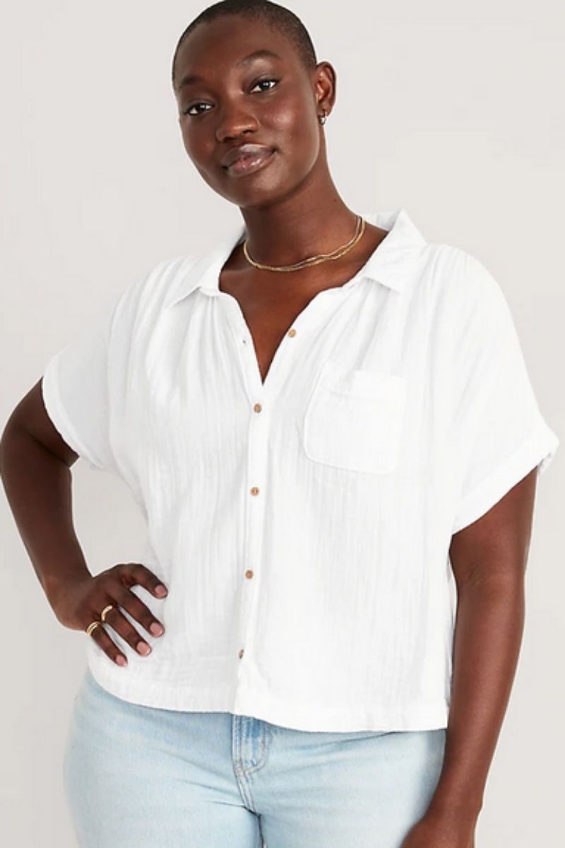 Woman wears white button-down top, part of the Old Navy summer clothes collection.