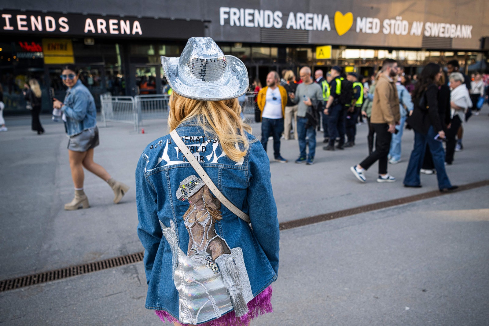 A fan of US musician Beyonce poses with her hand made jacket as she about to enter to the Friends Arena to watch her...
