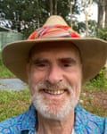 A selfie of a man with a white beard and moustache, wearing a decorated blue shirt and wide-brimmed hat