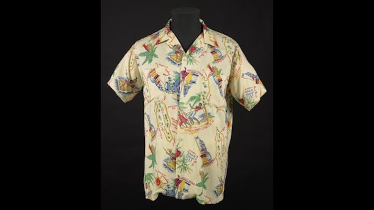 A cream shirt patterned with bright images of Jamaica.