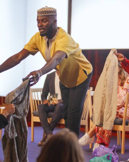 Sammy Oteng and Cynthia Essoun from Ghana-based advocacy group The Or Foundation hand out old clothes during a session of the Global Fashion Summit. The clothes had been imported to the giant Kantamanto secondhand fashion market in Ghana and were destined to end up in landfill after failing to sell.