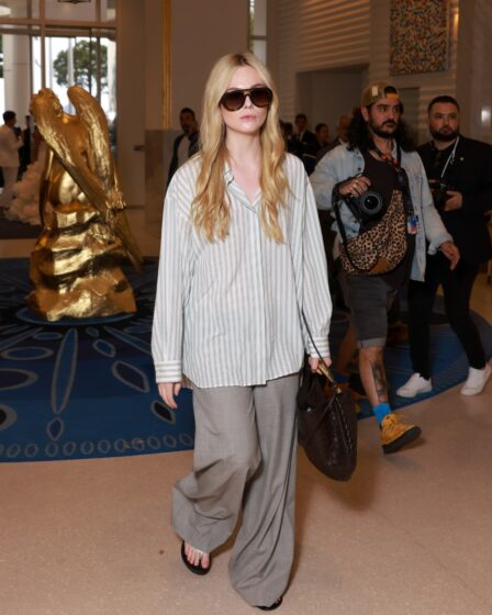 Elle Fanning demonstrates the “wrongshoe theory” in action sporting a pair of tailored trousers with flipflops while in...