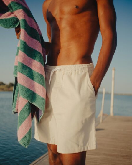man standing at the docks holding a towel