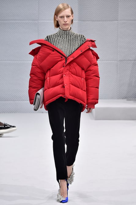 An off-shoulder red puffer coat by Balenciaga during Paris fashion week womenswear fall-winter 2016-17.