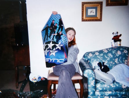 Evans as a teen, holding a signed ‘N Sync poster.
