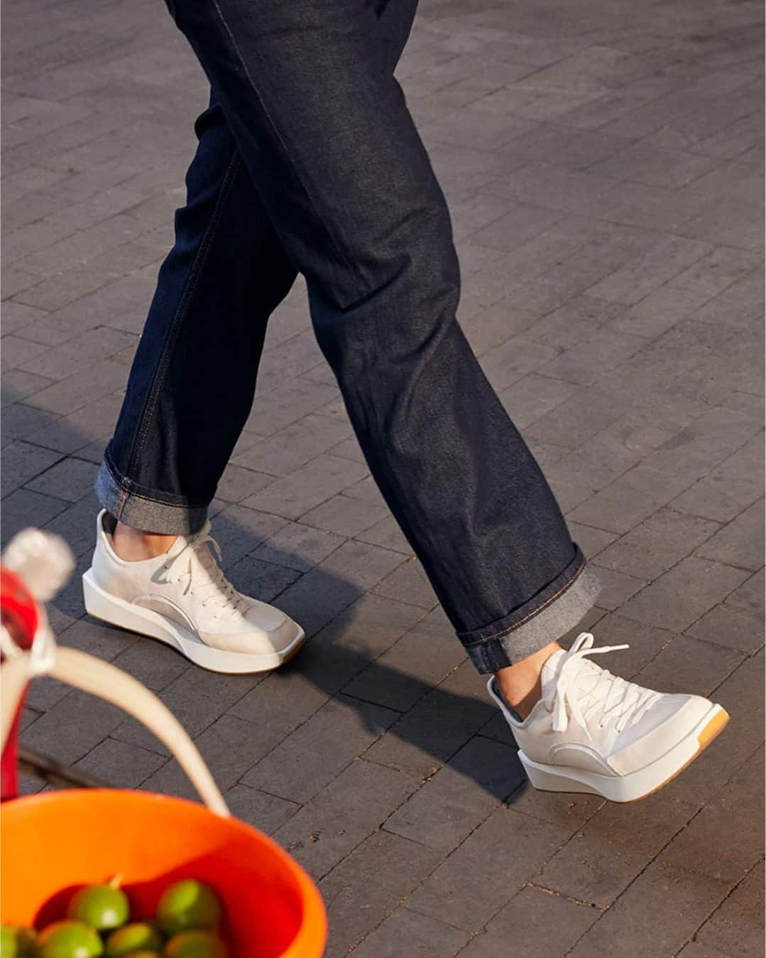 strolling with a pair of white sneakers